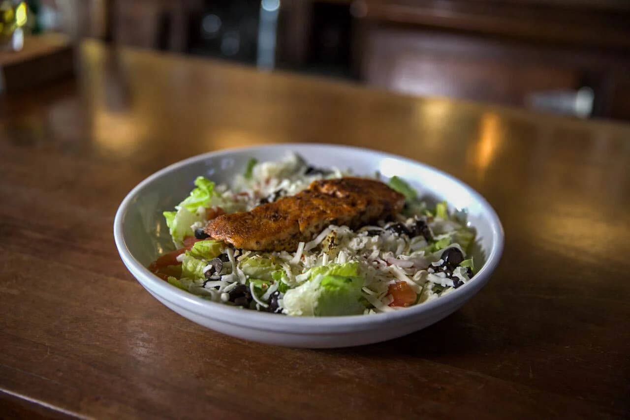 Blackened fish salad in a bowl