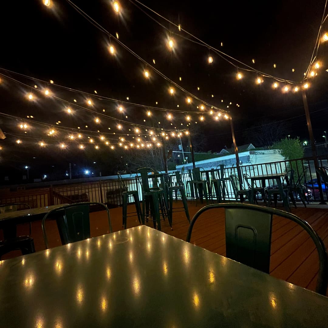The upstairs patio strung with lights